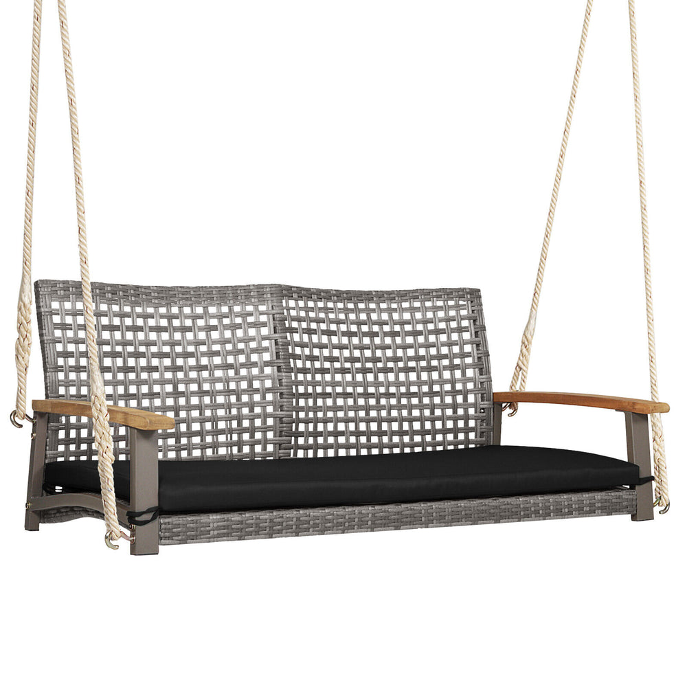 2-person patio wicker hanging swing chair with gray PE rattan, black cushion, and acacia wood armrests for outdoor.
