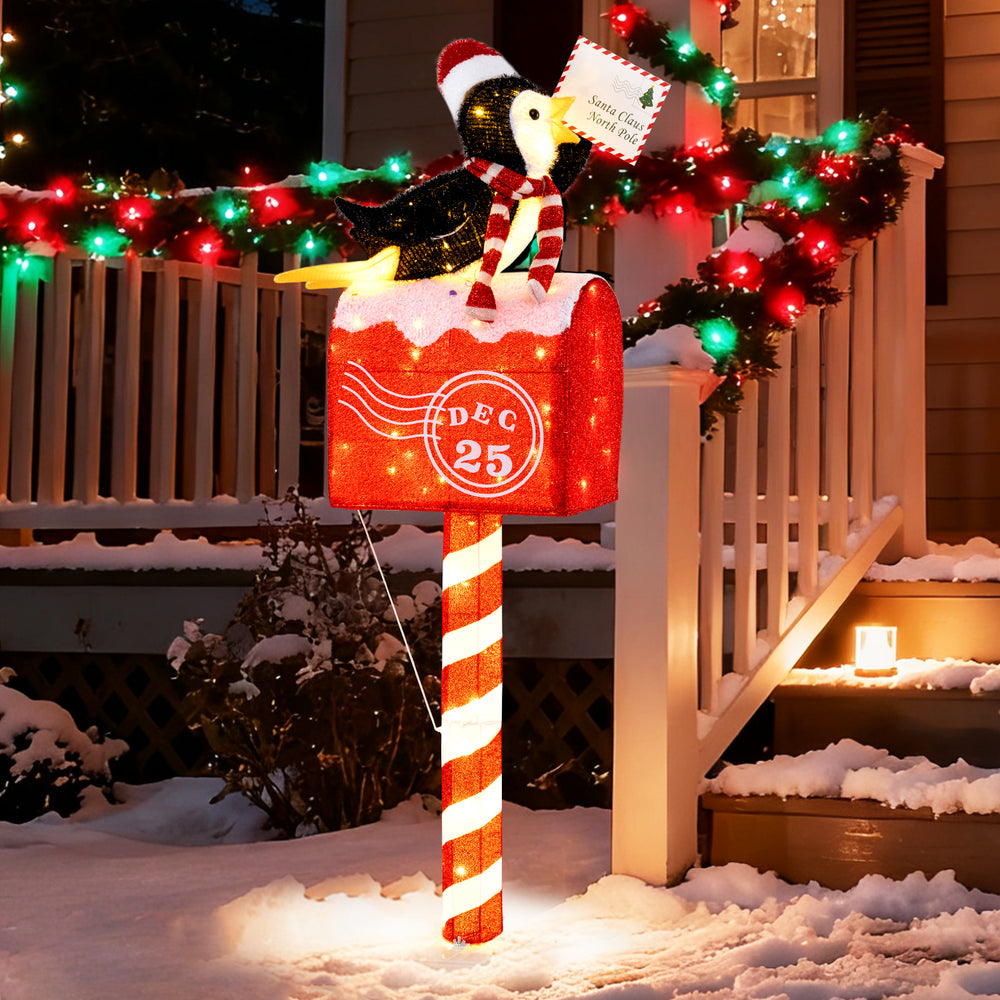Lighted penguin on mailbox decoration with 100 warm white LEDs, perfect for festive outdoor displays in winter.