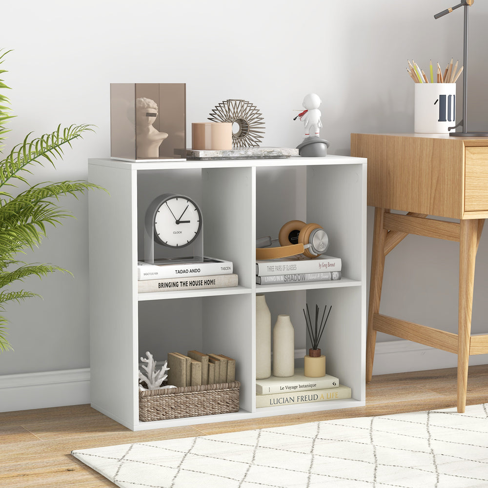 Four-cube bookshelf in white with back guardrail, ideal for storing books and decorations in living room or bedroom.