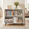 White 4-cube wooden bookshelf with 5 metal legs, ideal for organizing books and decor in living rooms or home offices.