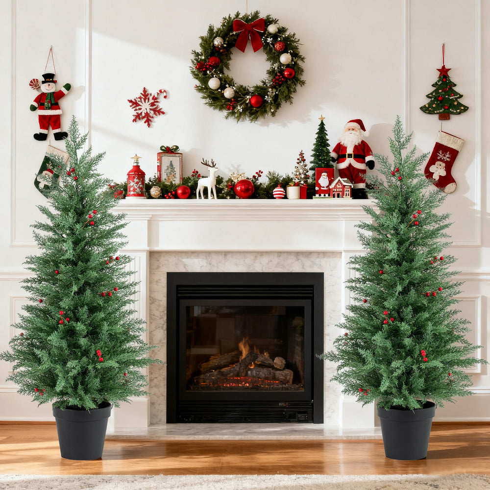 Two 4 FT pre-lit Christmas trees with 70 warm white LED lights and red berries, perfect for festive indoor decoration.