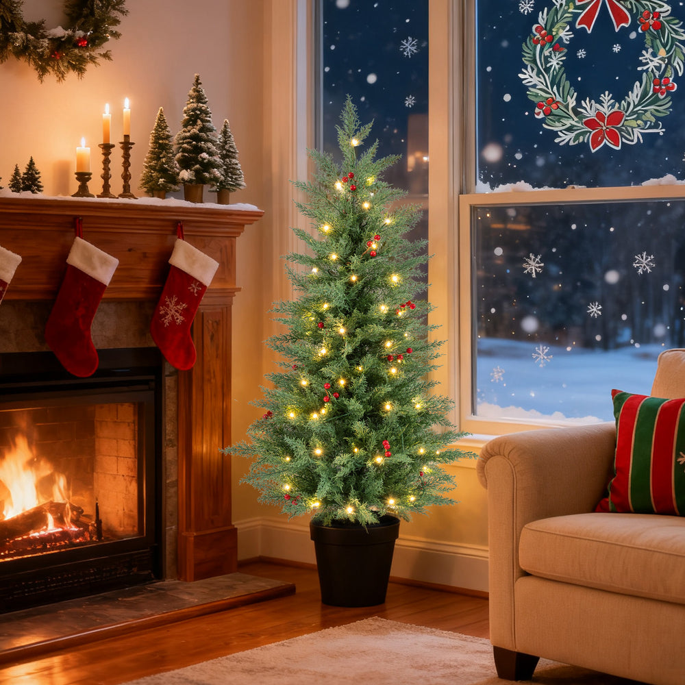 4 FT pre-lit Christmas tree with 70 warm white LED lights, decorated with red berries, ideal for cozy holiday decor.