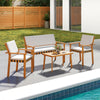 4-piece patio furniture set featuring acacia wood, soft cushions, and a coffee table, ideal for backyard relaxation.