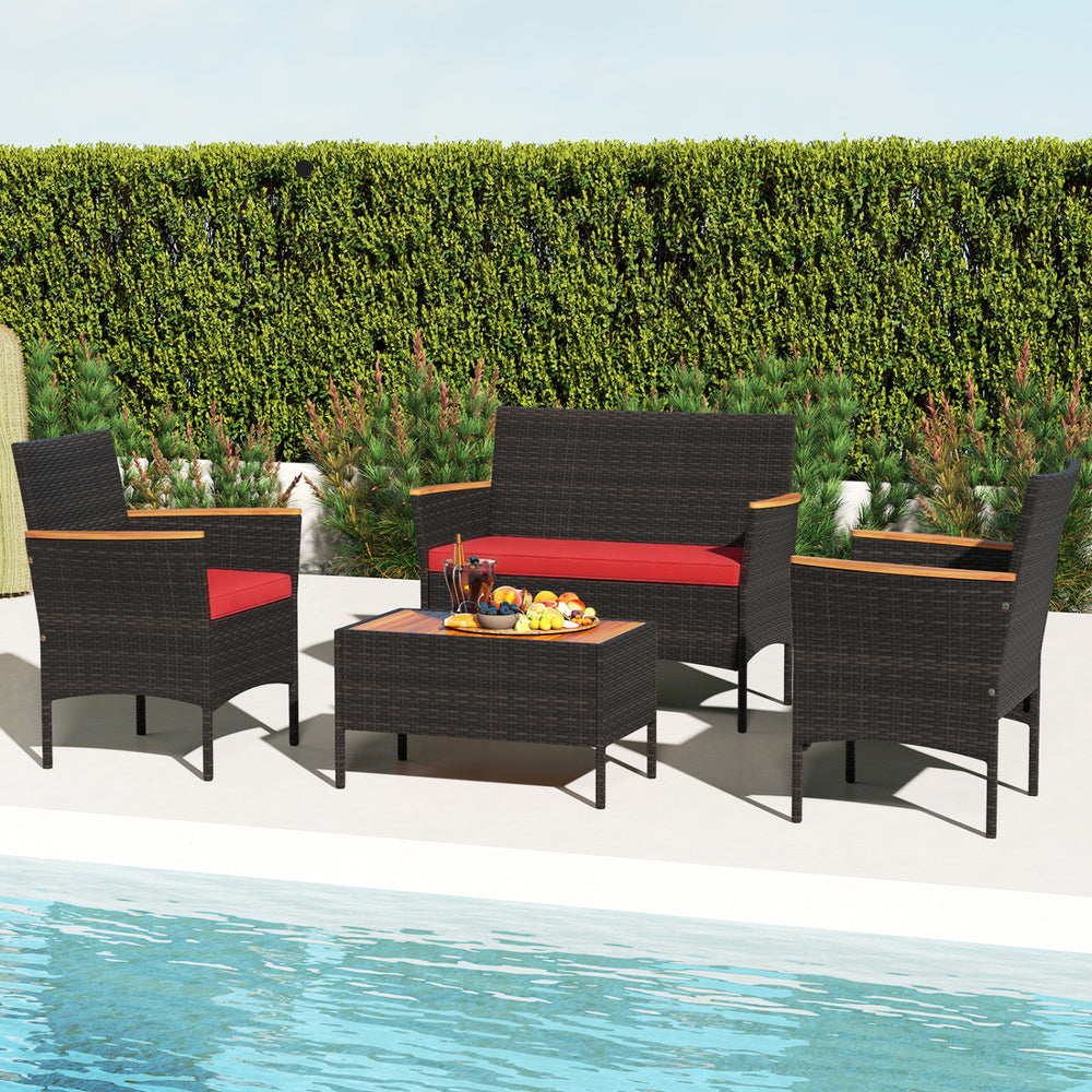 4-piece patio wicker sofa set featuring red cushions, acacia wood armrests, and a coffee table, perfect for outdoor.