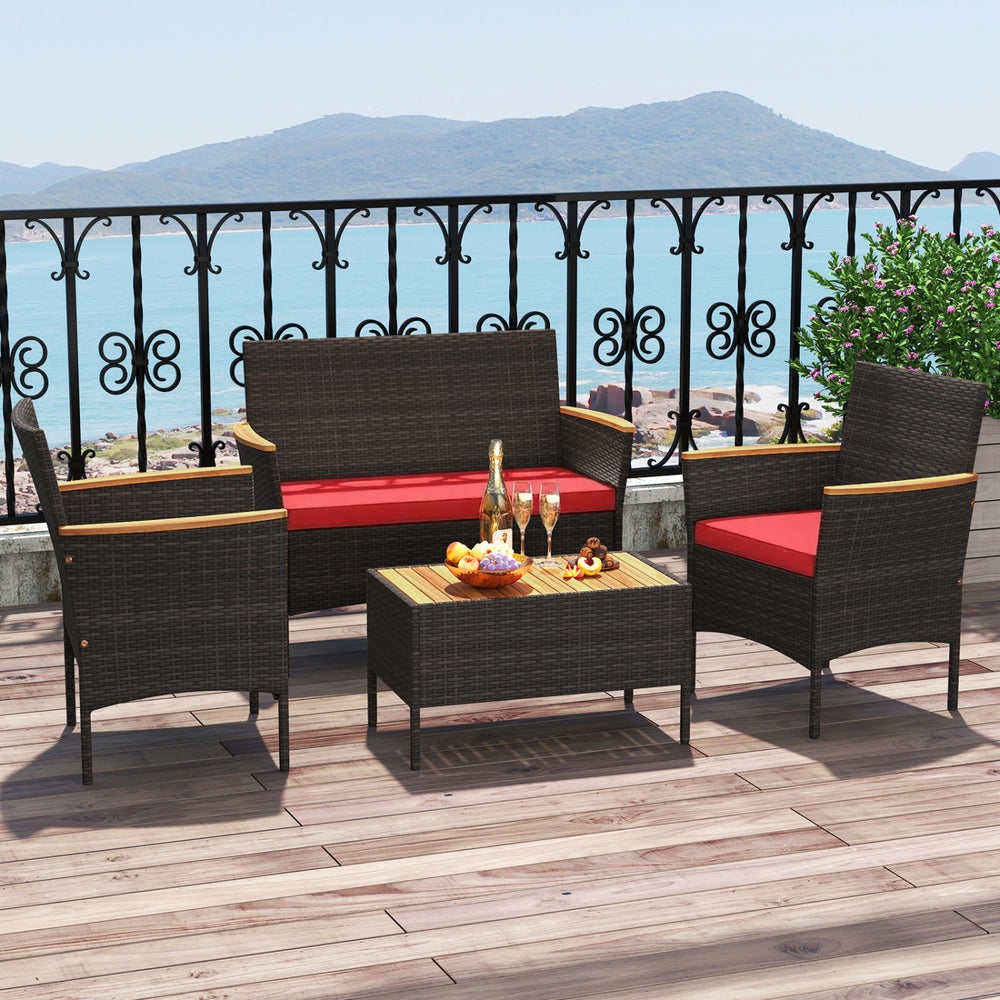 4-piece patio wicker sofa set featuring red cushions, acacia wood accents, and a stylish coffee table for outdoor.