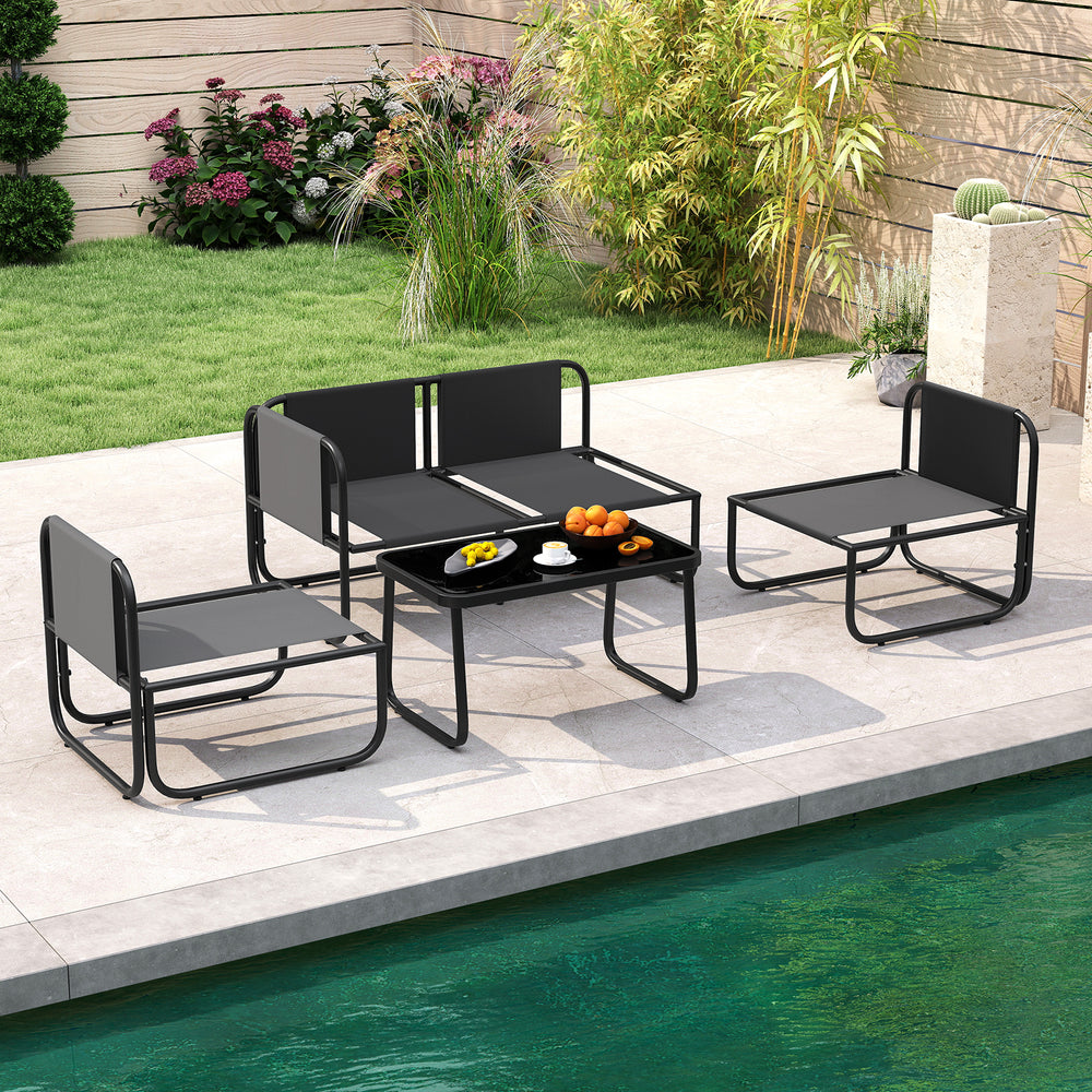 Gray 4-piece patio furniture set with cushions and coffee table, perfect for outdoor relaxation by the poolside.