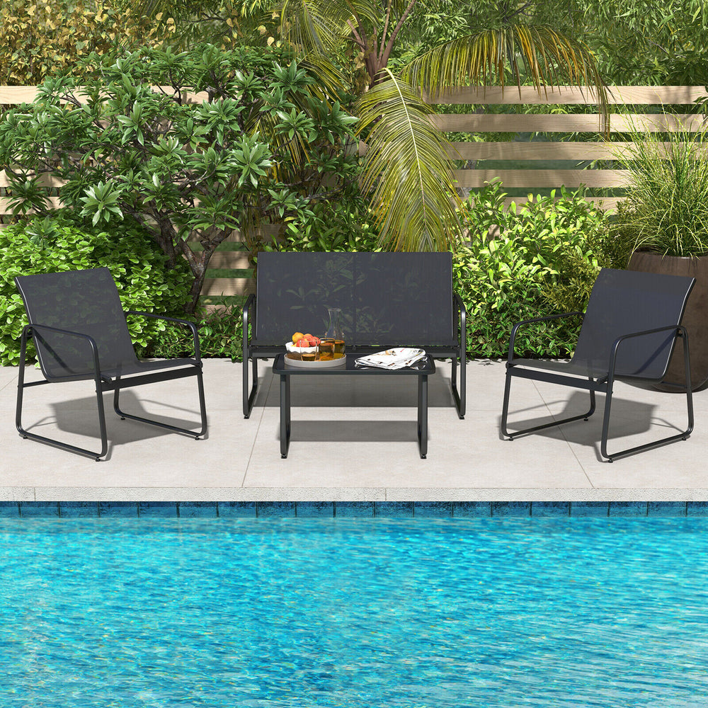 Four-piece outdoor conversation set featuring a tempered glass coffee table and breathable fabric chairs, perfect for.