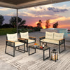 4-piece patio furniture set featuring a black loveseat and chairs with cream cushions, perfect for outdoor relaxation.