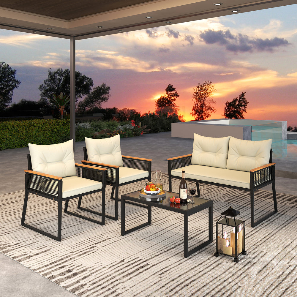 4-piece patio furniture set featuring a black loveseat and chairs with cream cushions, perfect for outdoor relaxation.