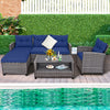 4-piece patio rattan sofa set with navy cushions and 2-tier coffee table, perfect for poolside or backyard relaxation.