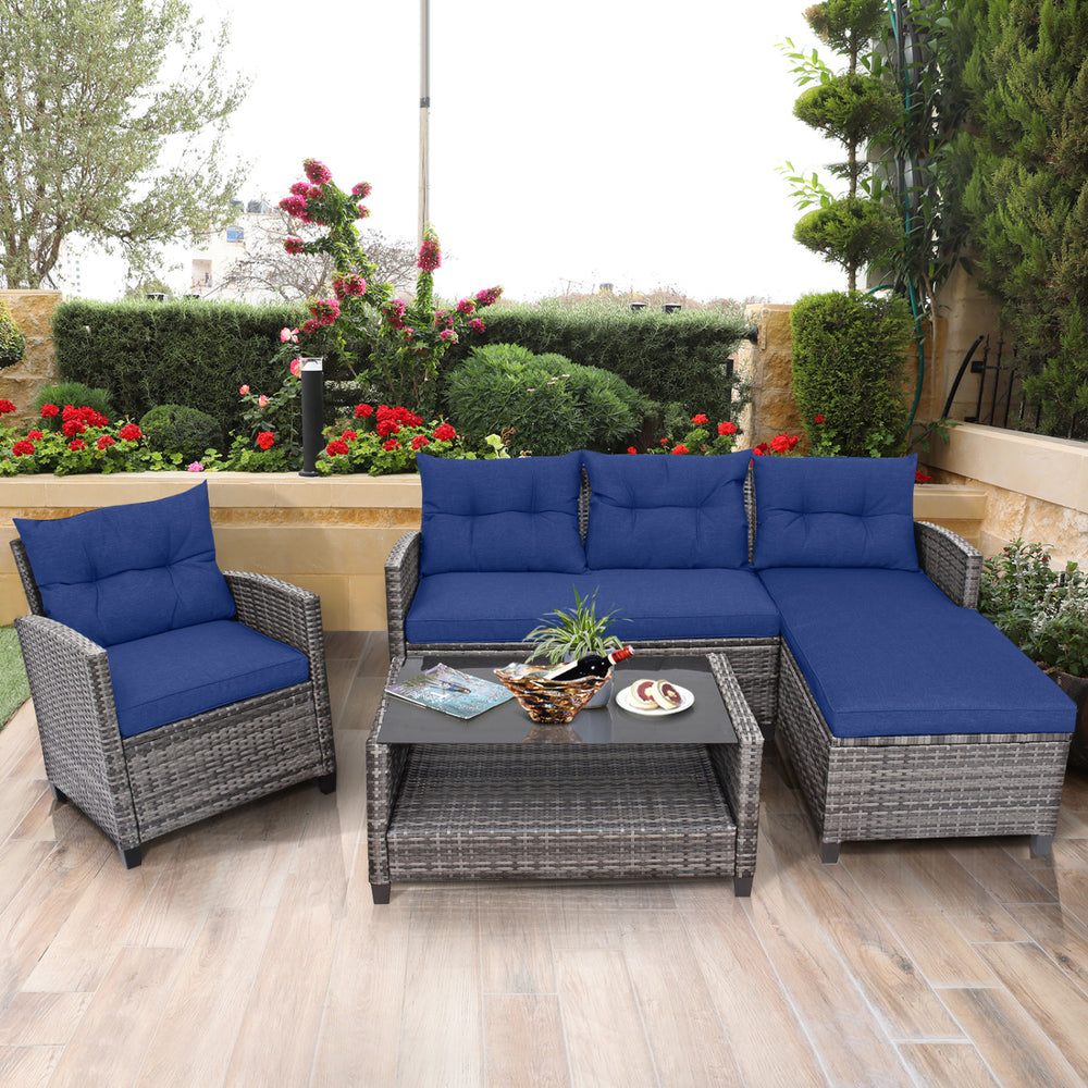 4-piece patio rattan sofa set with navy cushions and a 2-tier coffee table, perfect for outdoor relaxation.