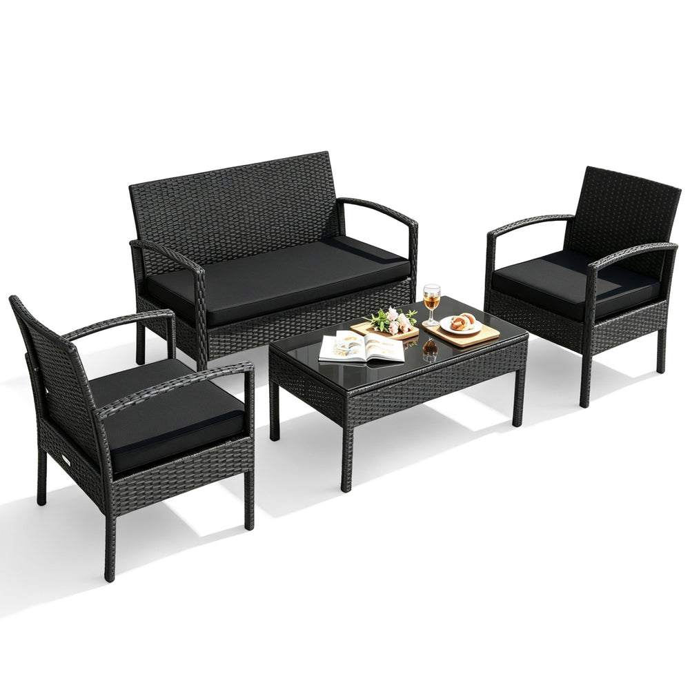4-piece patio rattan furniture set with cushions, featuring a loveseat, two single sofas, and a coffee table for outdoor relaxation.