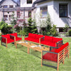 Red cushioned wood patio furniture set arranged in a garden, showcasing versatility and comfort for outdoor spaces.