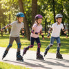 Adjustable blue roller skates with light-up wheels, worn by kids skating in a park for fun and safety.