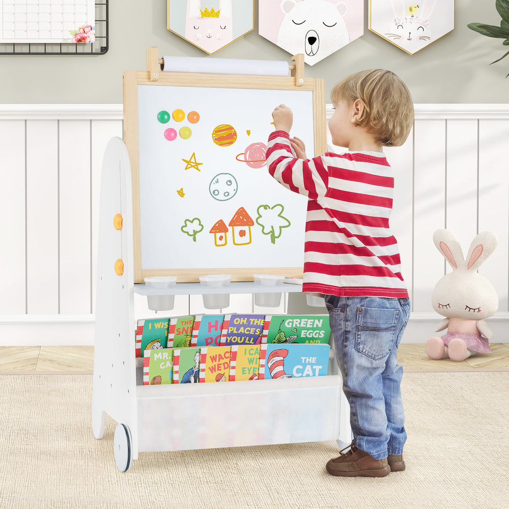 Toddler using the 4-in-1 activity table set with a magnetic whiteboard and chalkboard for creative play.