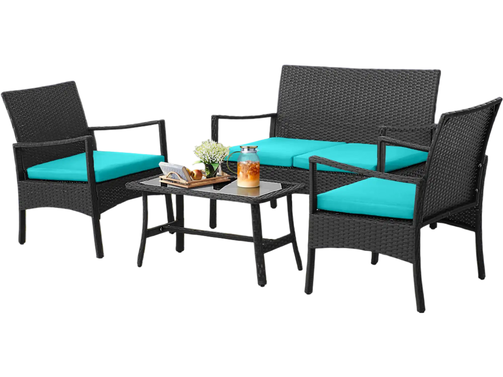 Rattan conversation set featuring a loveseat, two chairs, and a tempered glass coffee table with turquoise cushions by.