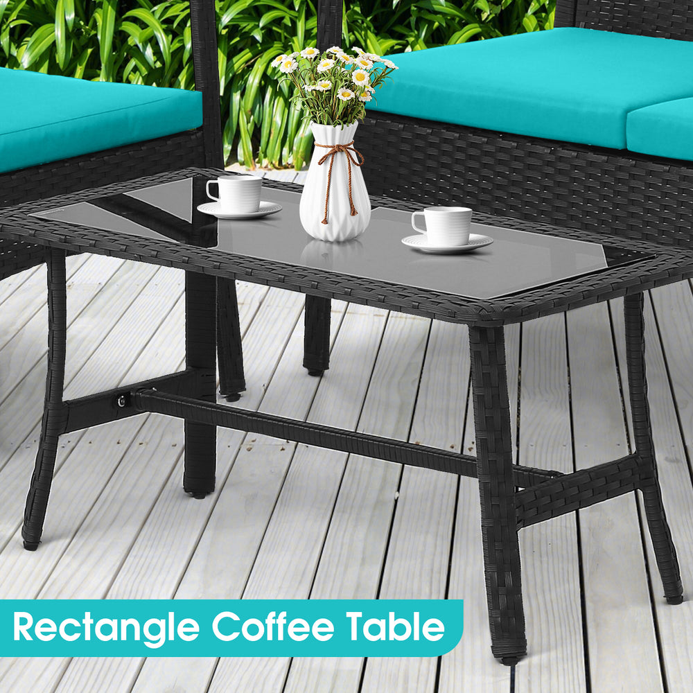 Rectangular coffee table with tempered glass top and PE wicker base, ideal for outdoor seating arrangements.