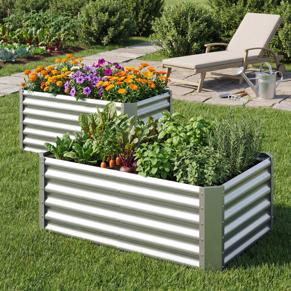 Galvanized metal raised garden bed with vibrant flowers and herbs, ideal for backyard or patio gardening.