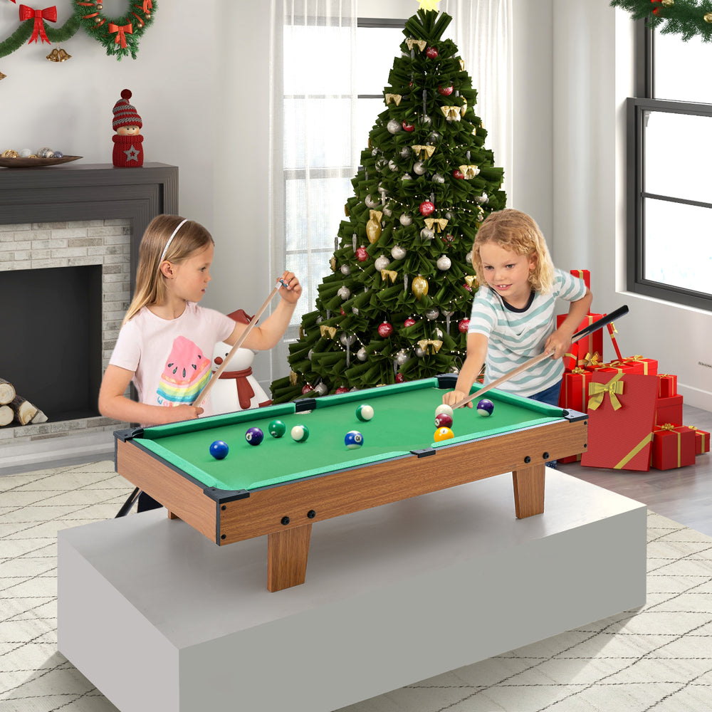 Kids playing on the 4-in-1 combo game table set featuring billiards and foosball, perfect for family fun.