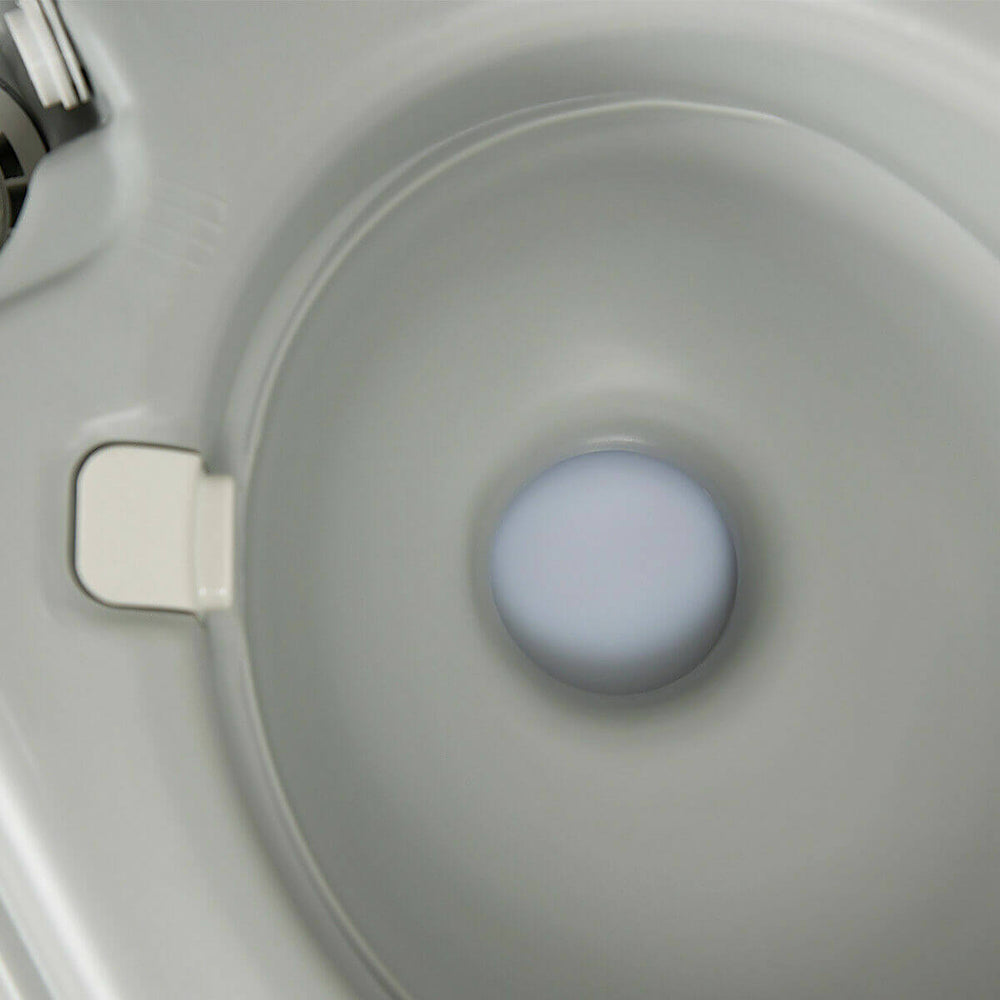 Close-up view of the 5.3-gallon portable travel toilet bowl, designed for outdoor activities and easy flushing.