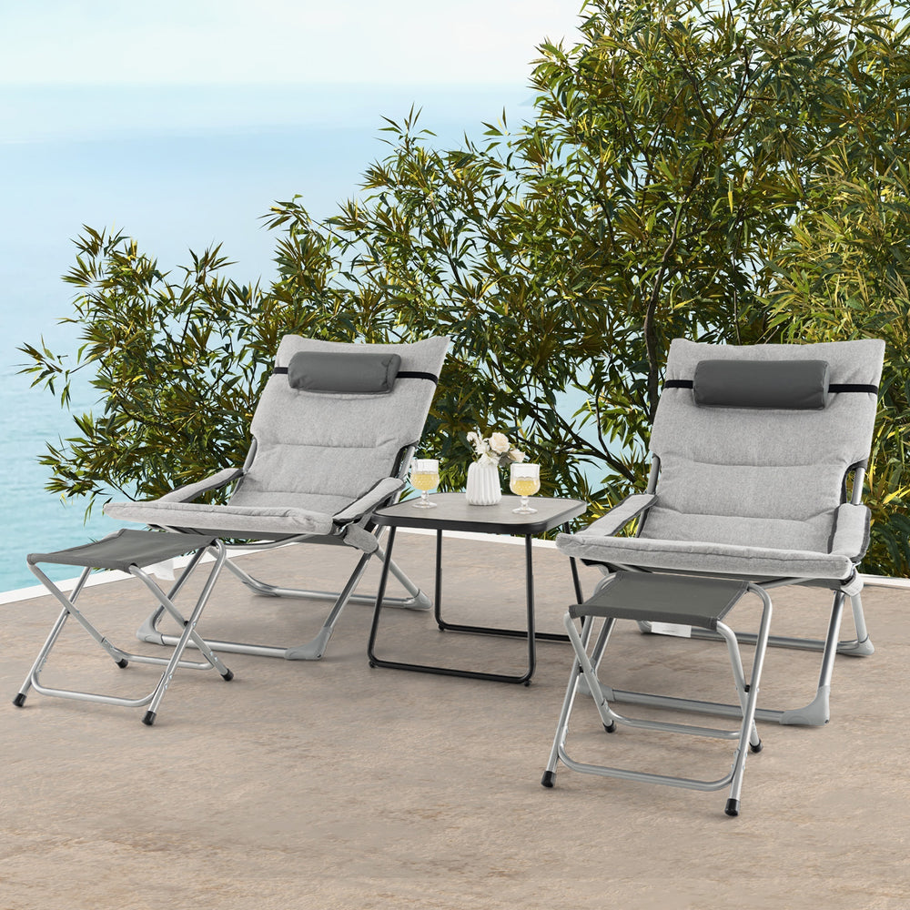 Folding lounge chairs with footrests and coffee table in gray, perfect for patio relaxation and easy storage.