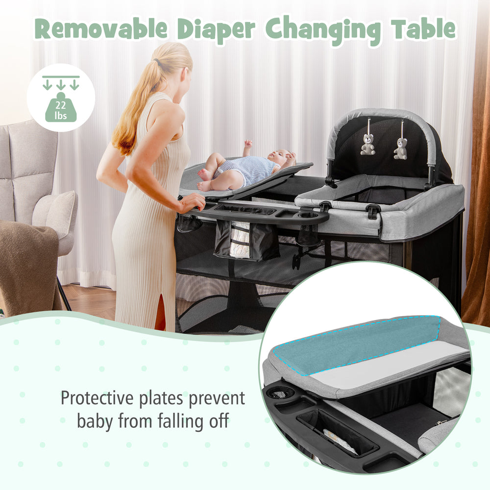 Removable diaper changing table on a portable baby playard, featuring sturdy construction and safety features for.