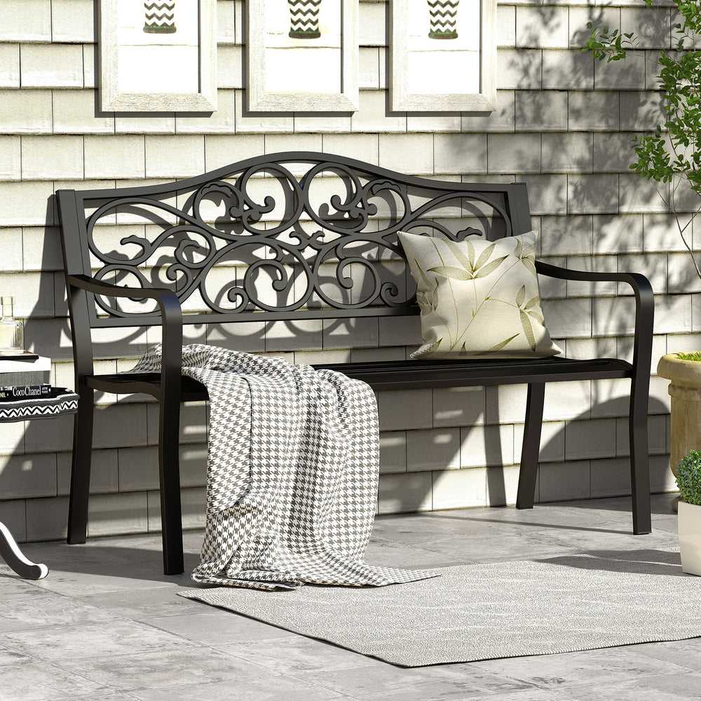 Black 50-inch outdoor cast iron patio bench with floral design backrest, slatted seat, and cozy cushions for garden use.