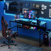 Black 55 x 24 inch computer desk with built-in power outlets, USB ports, and spacious under-desk storage for gaming.