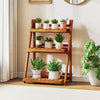 Foldable 3-tier solid wood plant stand featuring a stable triangular structure, perfect for showcasing plants indoors.