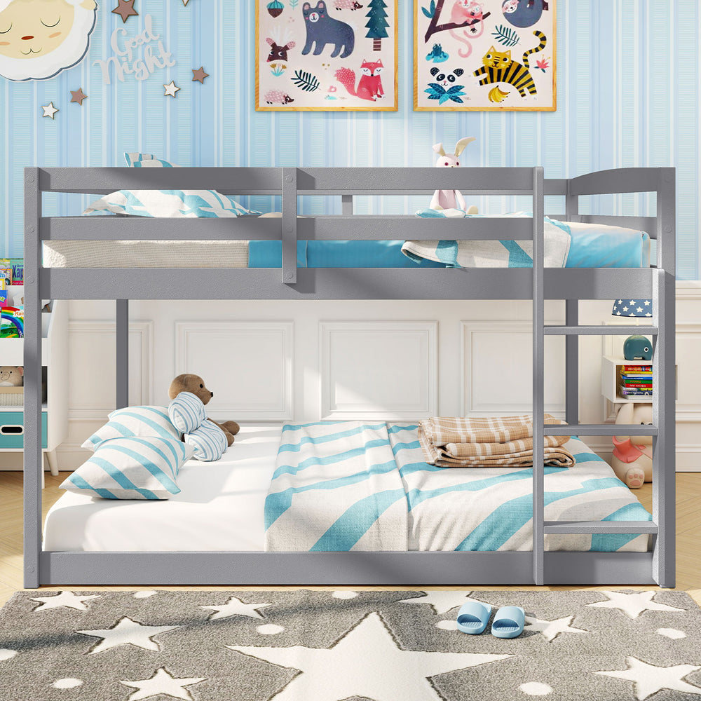 Low-to-ground gray full over full bunk bed featuring spacious sleeping areas, ideal for children’s comfort and safety.