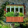 Wooden decorative planter box filled with vibrant plants, perfect for enhancing windows or patios with natural beauty.