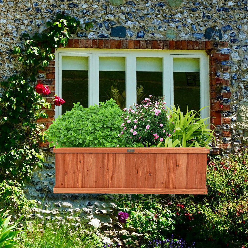 Wooden decorative planter box filled with vibrant plants, perfect for enhancing windows or patios with natural beauty.