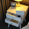 White wooden nightstand with two storage drawers, perfect for bedroom decor and efficient space use.