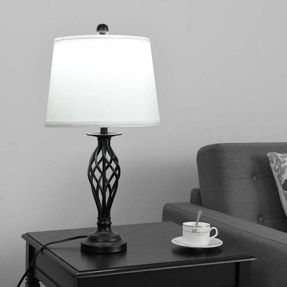 Black metal table lamp with white fabric shade, perfect for traditional decor in living room or bedroom settings.