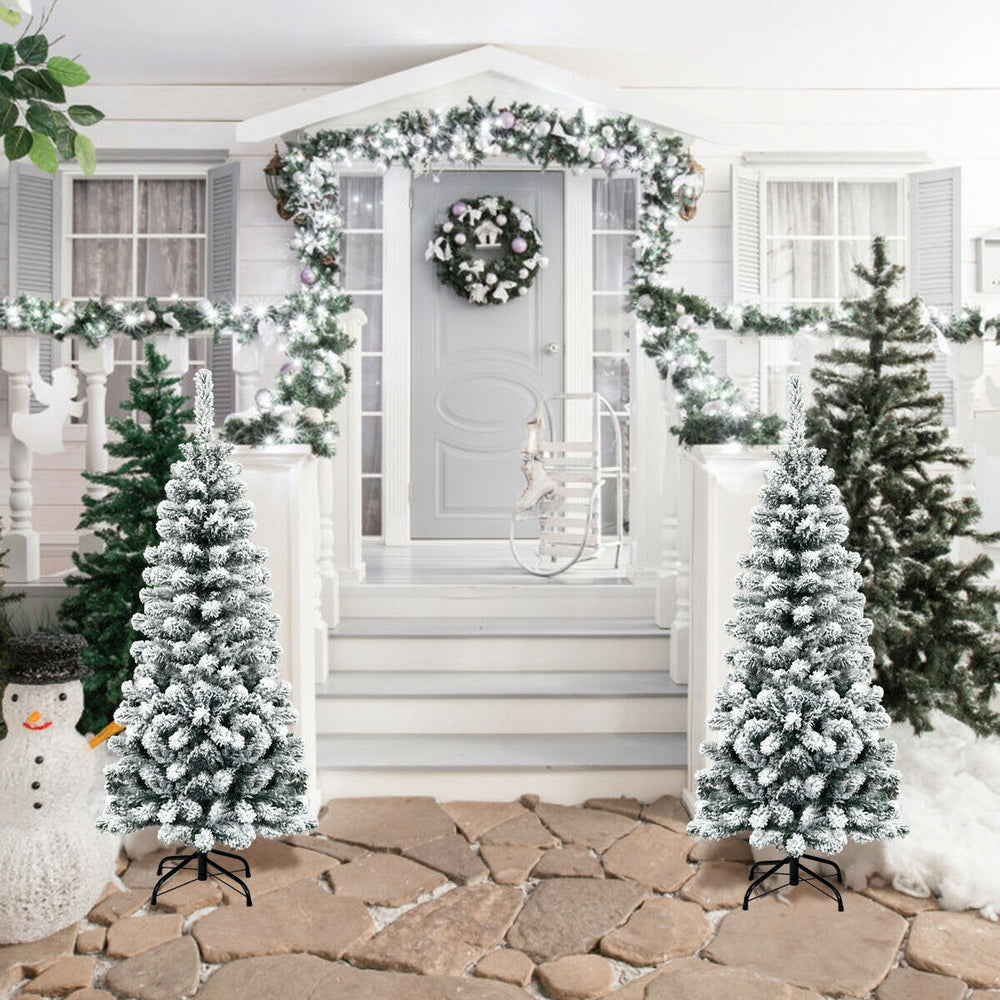 Snow flocked 4.5 feet unlit pencil Christmas tree with 242 branches, perfect for limited spaces and festive decor.