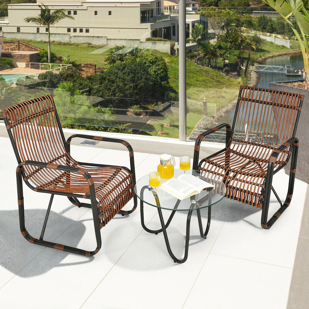Two single wicker chairs and a glass side table from a 3-piece patio rattan furniture set for outdoor relaxation.