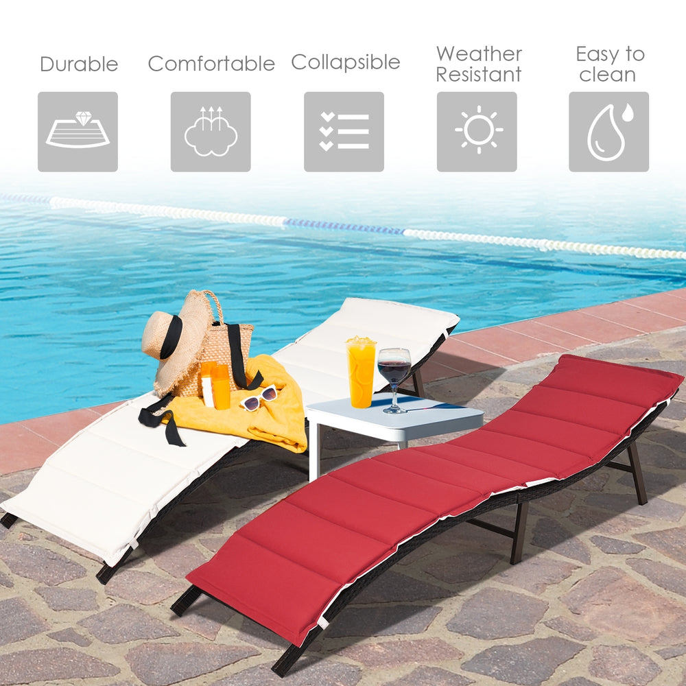 Folding patio lounger chairs in red and beige with premium wicker, perfect for poolside relaxation and easy storage.
