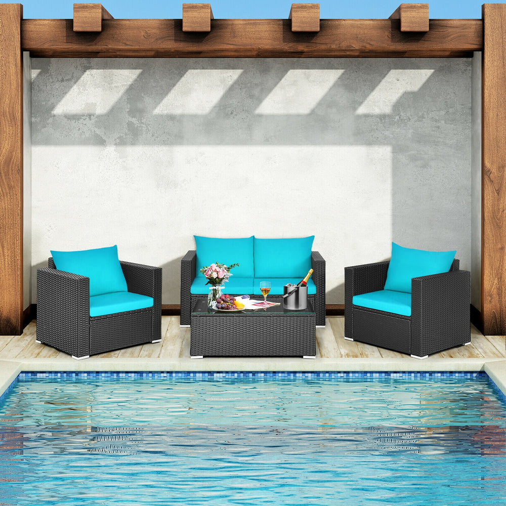 Patio rattan furniture set with turquoise cushions, featuring a coffee table with tempered glass, ideal for poolside.