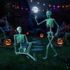 Life-size 5.5 FT Halloween skeletons with green light, posable for indoor or outdoor decoration, perfect for spooky.