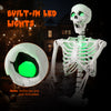 Life-size Halloween skeleton with posable joints and glowing green LED eyes, perfect for indoor or outdoor decoration.