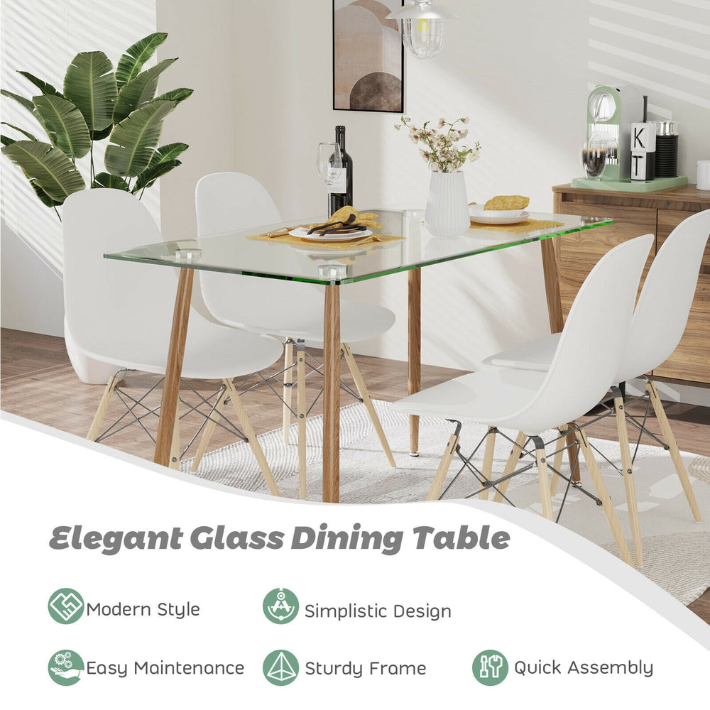 Modern glass rectangular dining table with sturdy metal legs, perfect for home or office use, featuring a clear.
