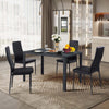 Modern dining set featuring four black leather chairs with metal frames, ideal for dining rooms and elegant gatherings.