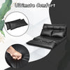 Foldable PU leather leisure floor sofa bed in black with two pillows, adjustable for lounging or sleeping in small.