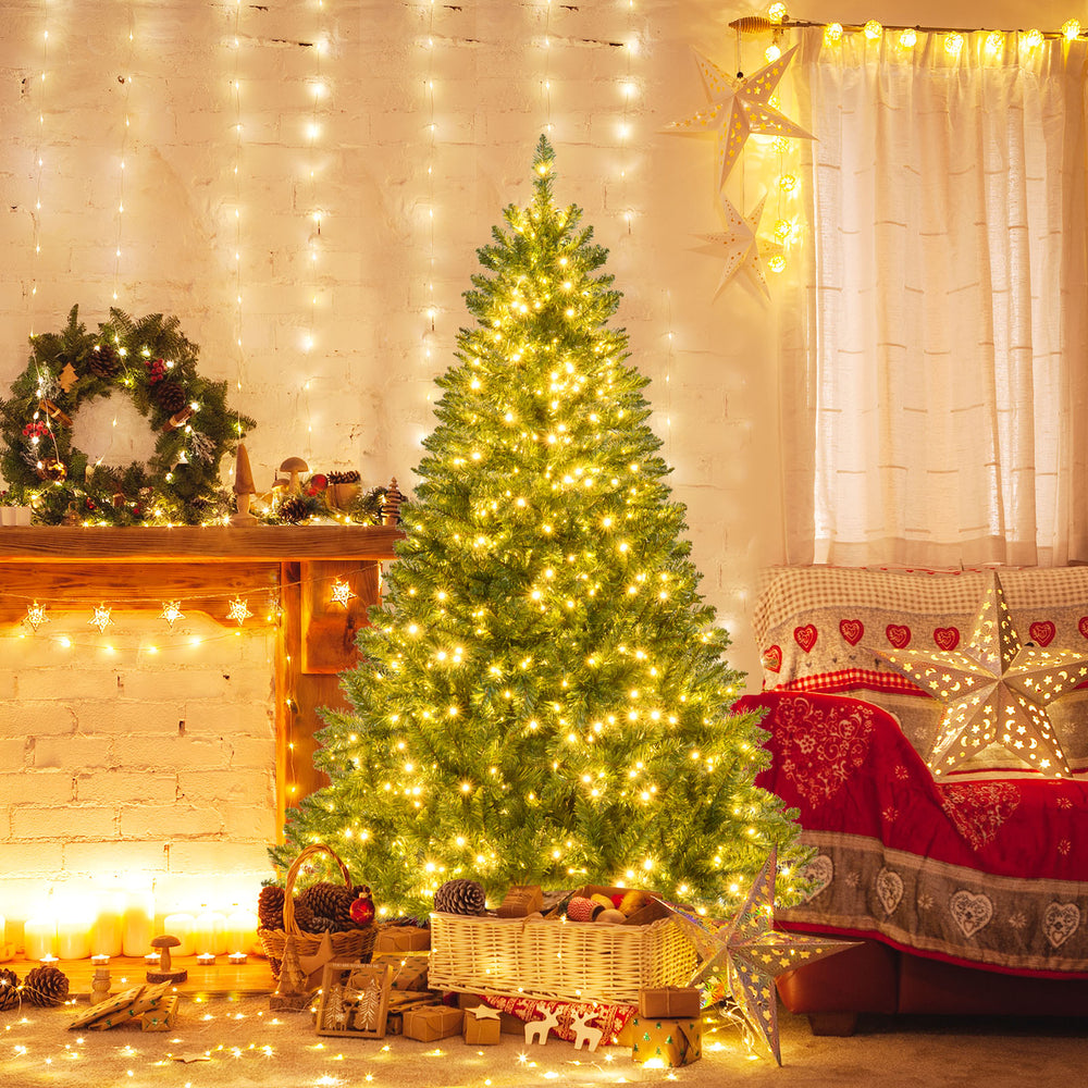 6-foot artificial Christmas tree adorned with warm white LED lights, set in a cozy holiday scene with decorations.