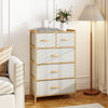 5-drawer dresser in natural bamboo with top shelf, featuring fabric drawers and solid beech handles for bedroom storage.