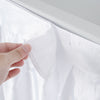 Close-up of the table skirt with hook and loop fasteners on the 5 FT Folding Ice Cooler Table for easy removal.