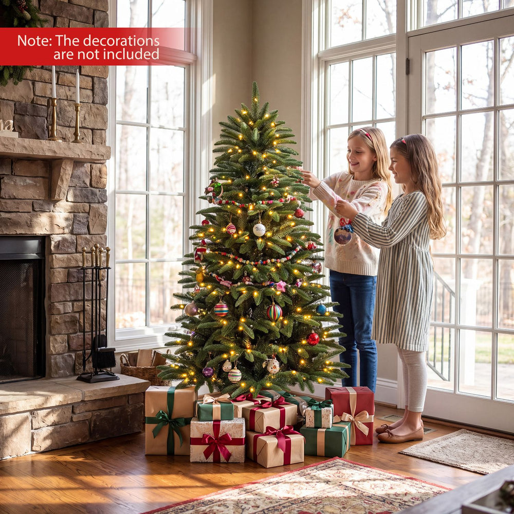 Pre-lit artificial Christmas tree with warm LED lights and three gift boxes, perfect for festive indoor celebrations.