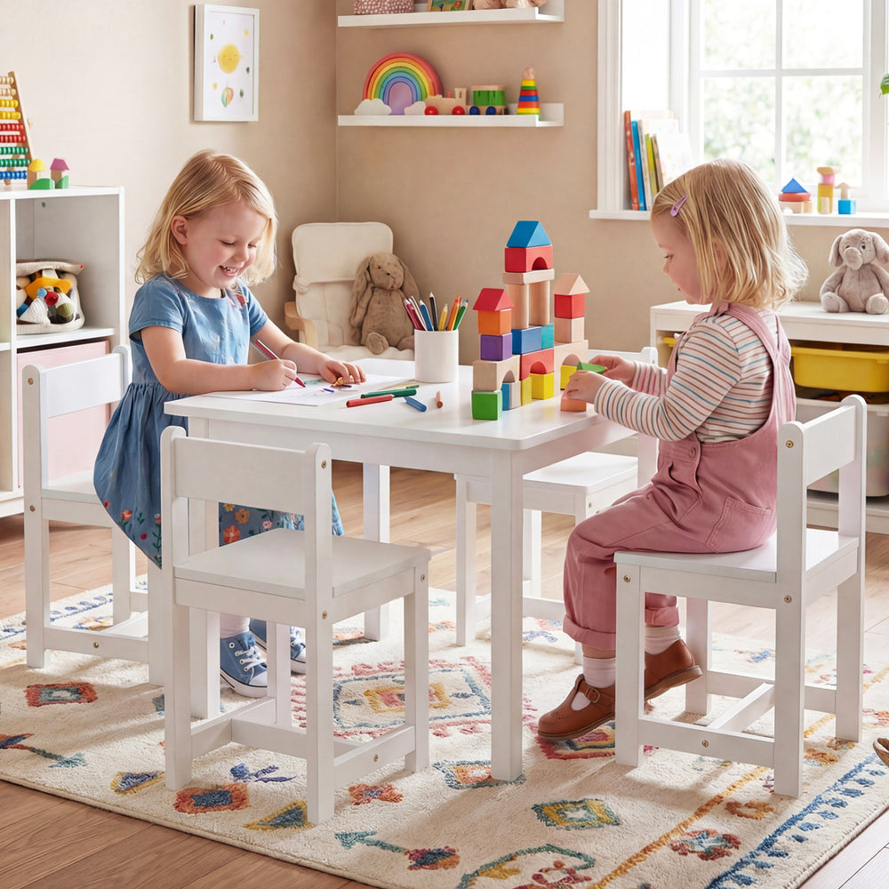 Kids playing at a white 5-piece table and chairs set made of solid rubber wood, perfect for activities in playrooms.