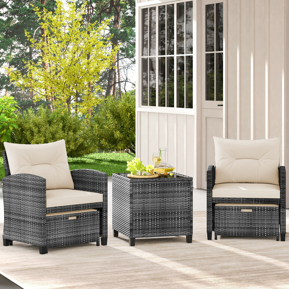 Two gray rattan chairs with cream cushions and a square coffee table, ideal for outdoor patio relaxation.