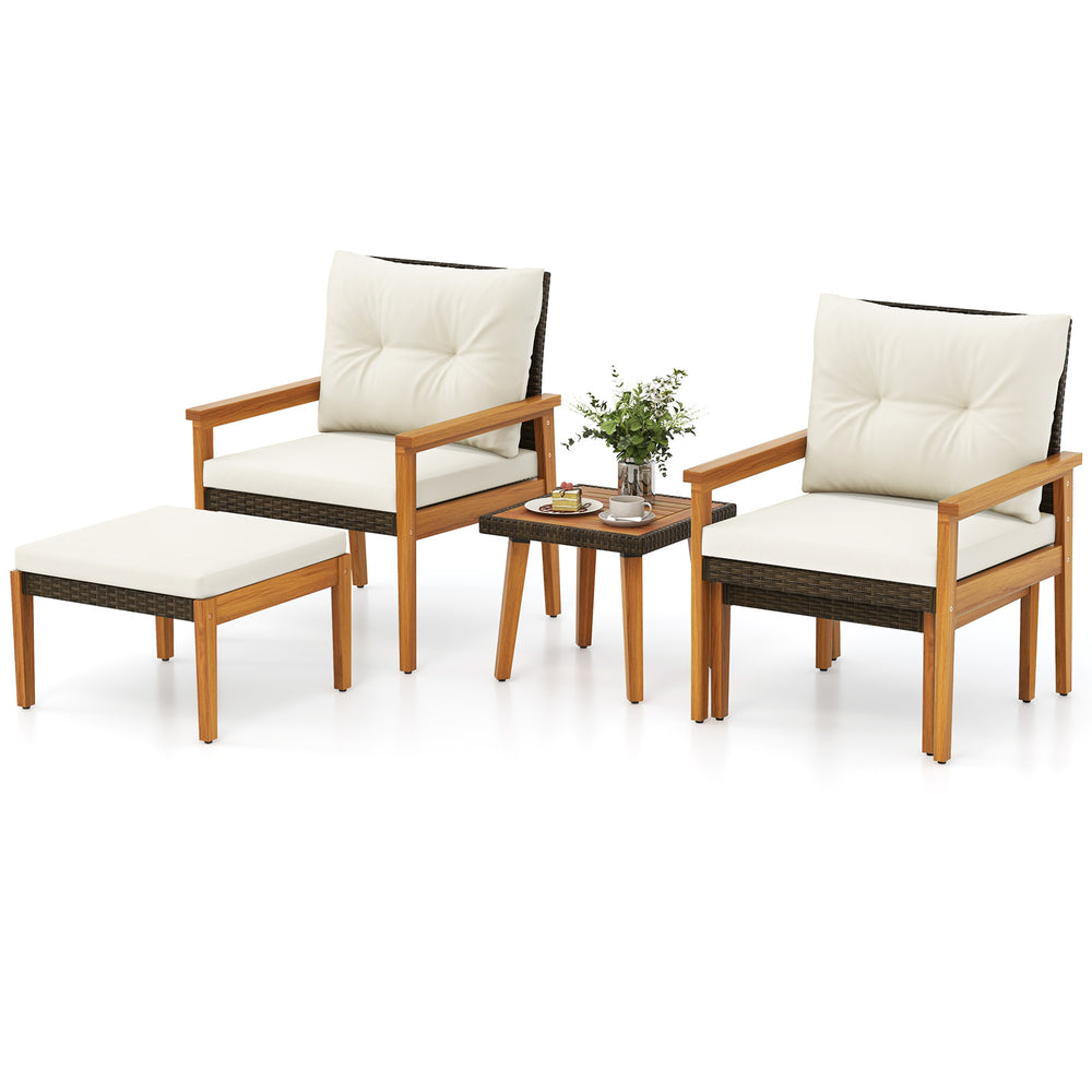 Two cushioned chairs and an ottoman from a 5-piece rattan furniture set with a square coffee table for outdoor.